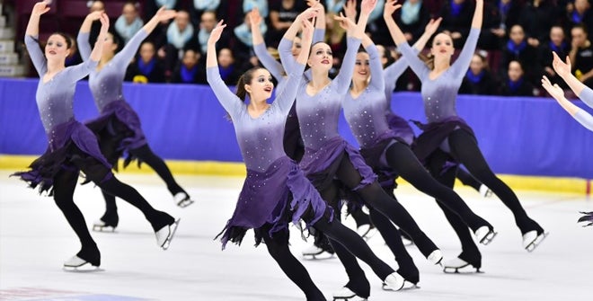 Synchronized women skaters performing on the ice